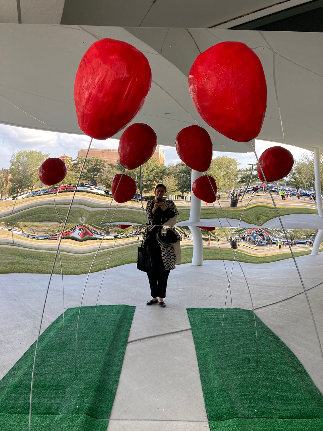 Image of mirrored wall with pathway lined with paper ballons by Alissa Kono