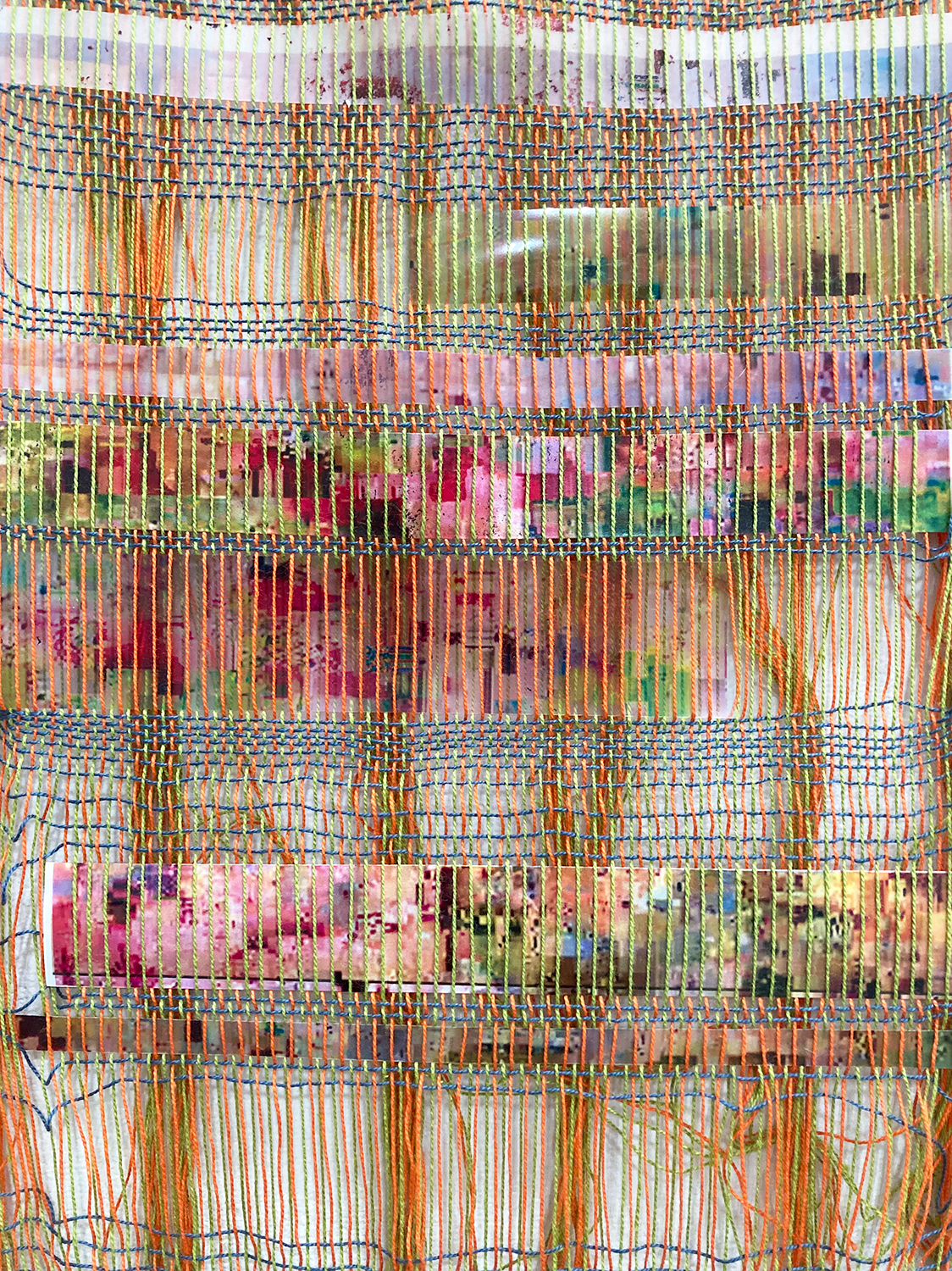 close up of brightly colored thread woven with celluloid film woven through it