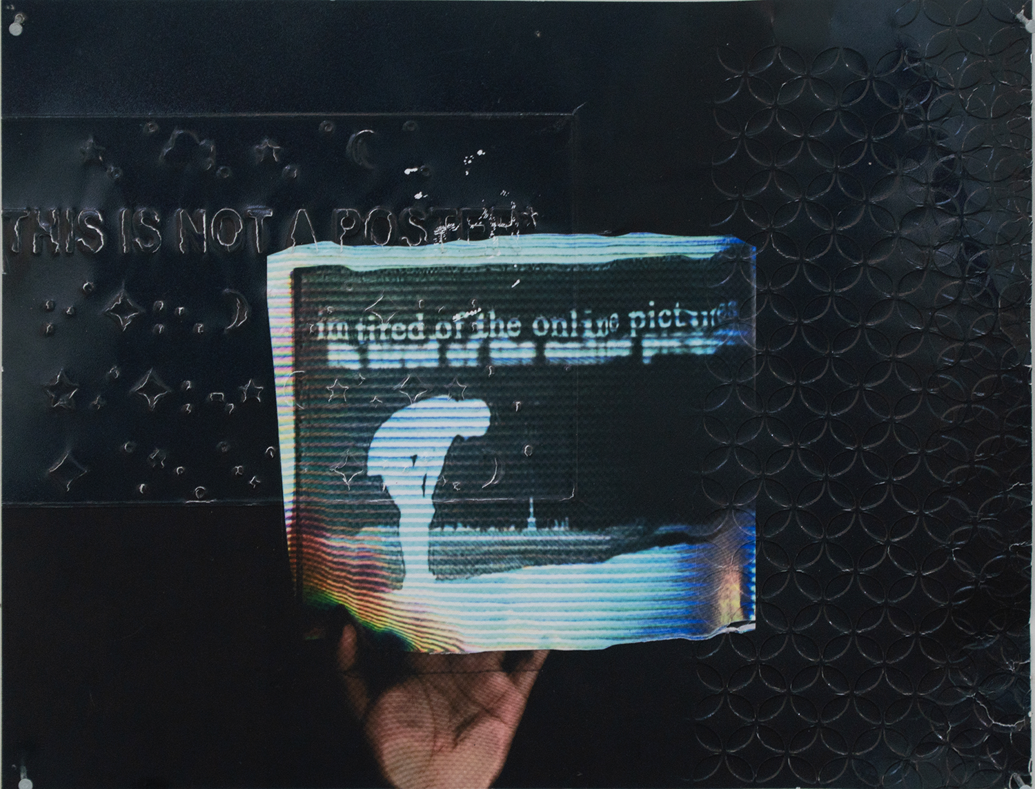 A Xerox copy of a hand holding a printed message