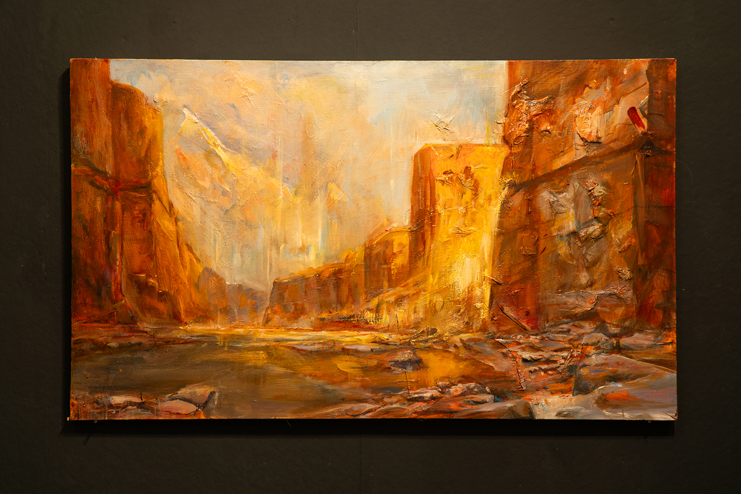Painting of a landscape in rich reds and oranges