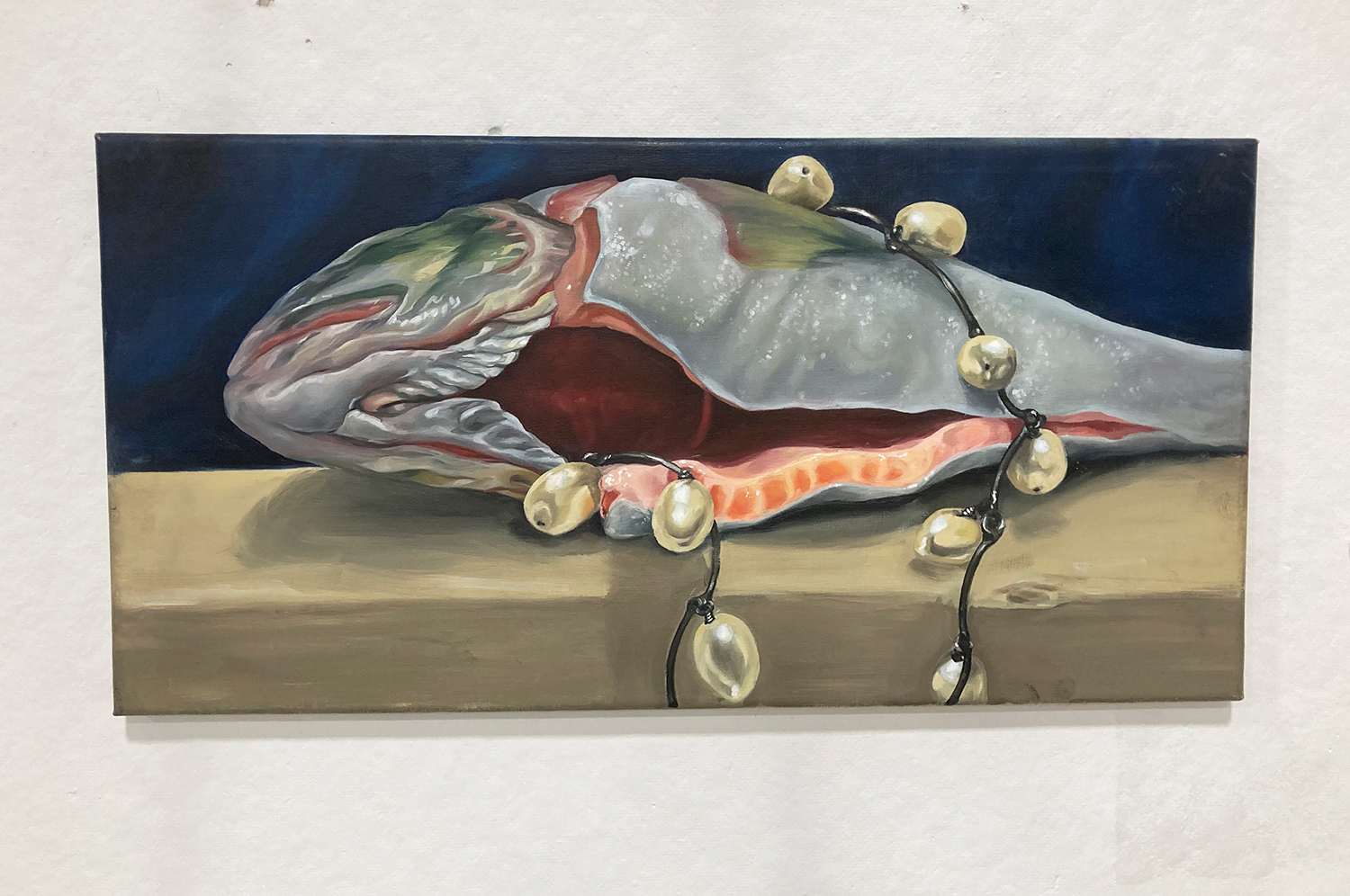 Oil painting of a gutted fish and lights around it by Siena Damiani