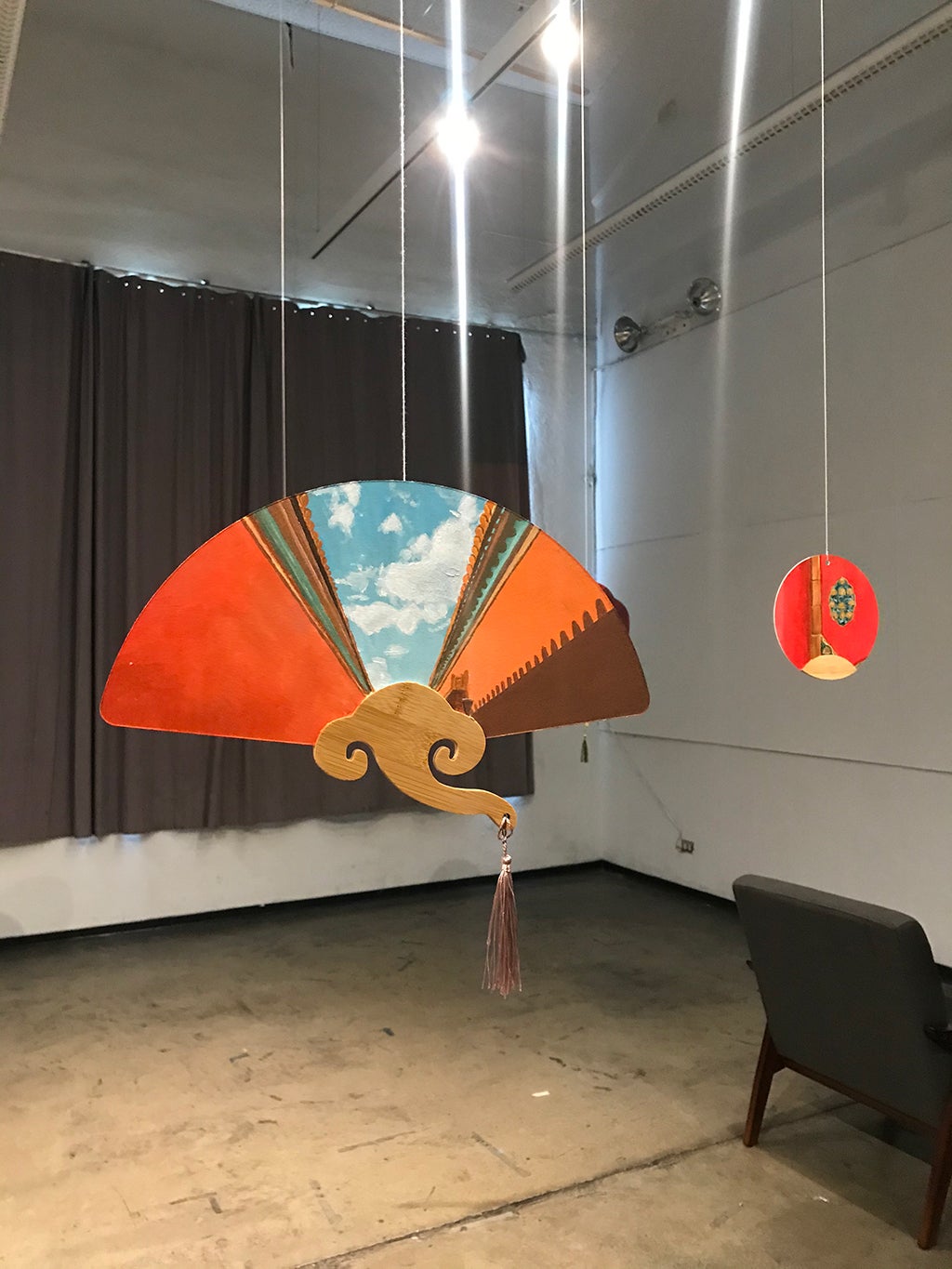Closeup image of painted on, hanging fans.