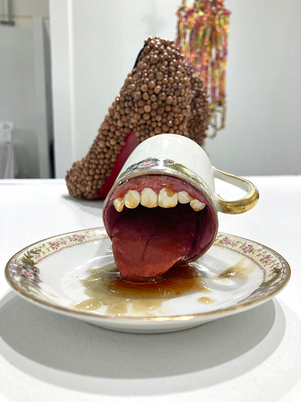 Ceramic tea cup turned over with a mouth.