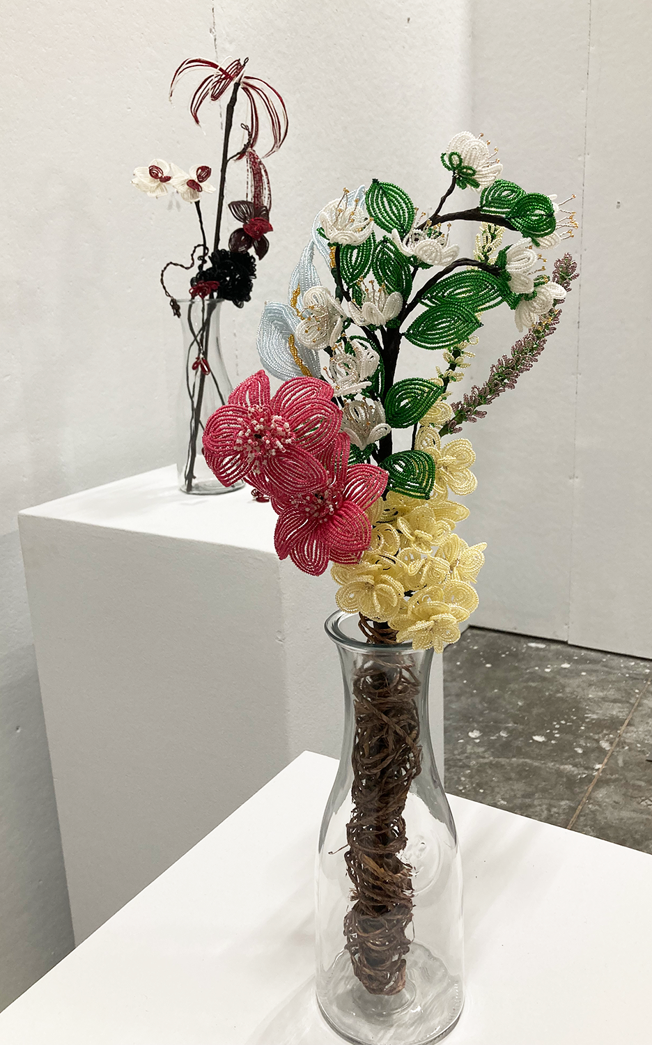 Flowers made of glass seed beads in vases