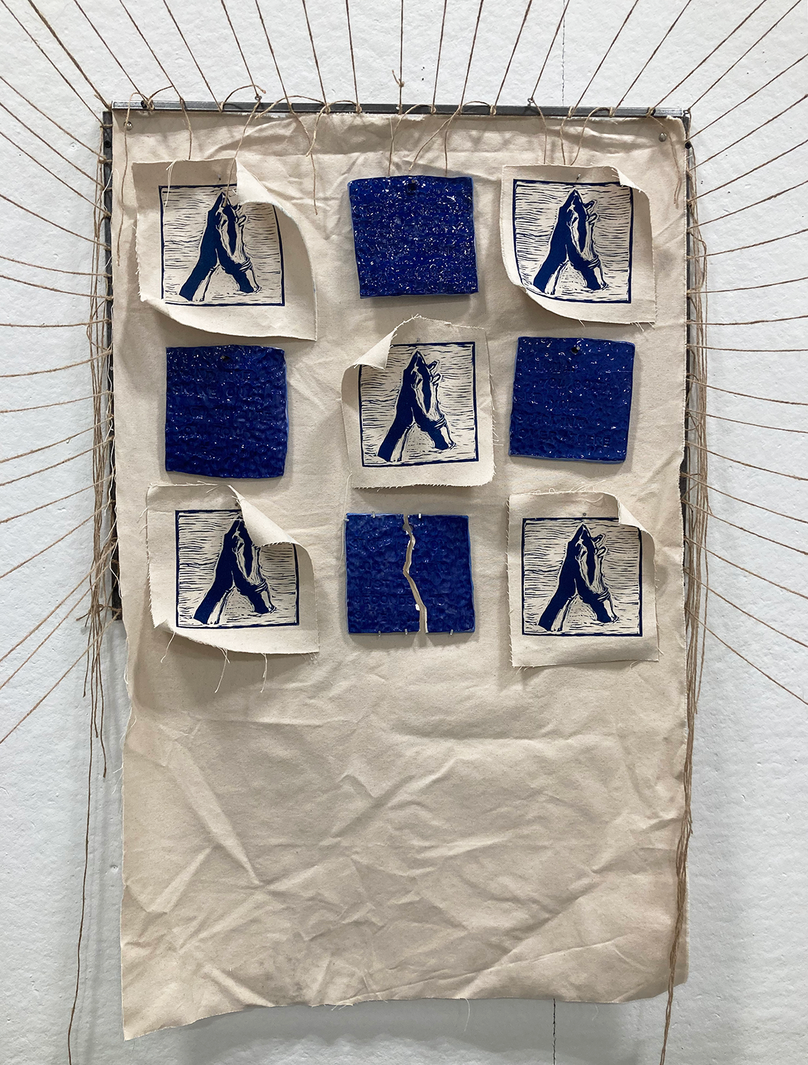 Close-up of installation of twine, ceramics, steel, canvas, ink